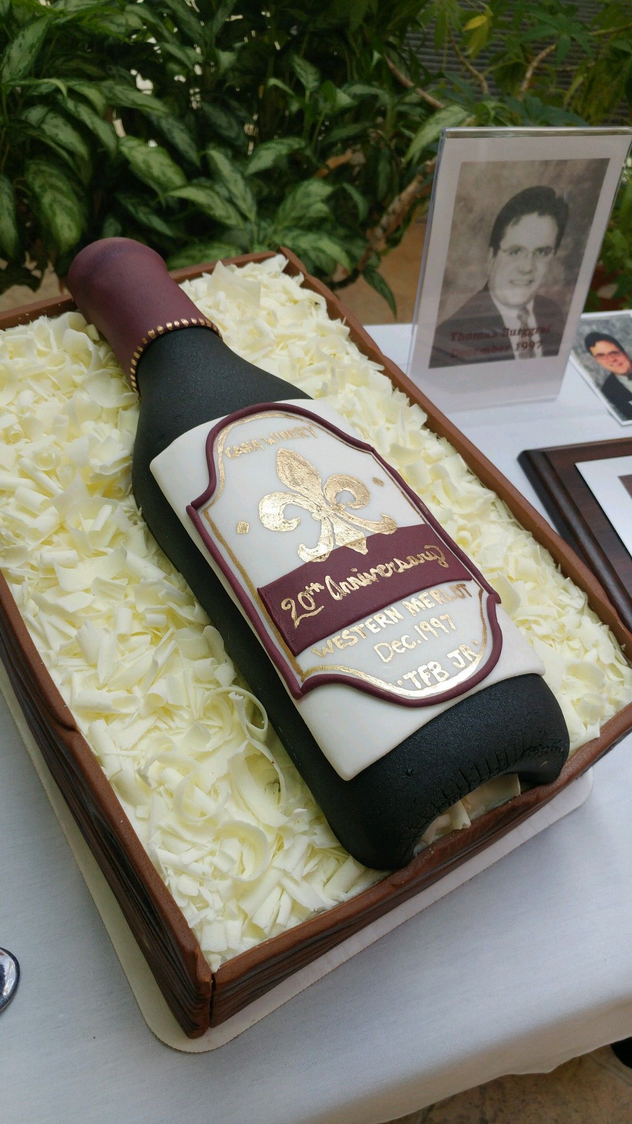 A cake with a bottle of wine on top of it