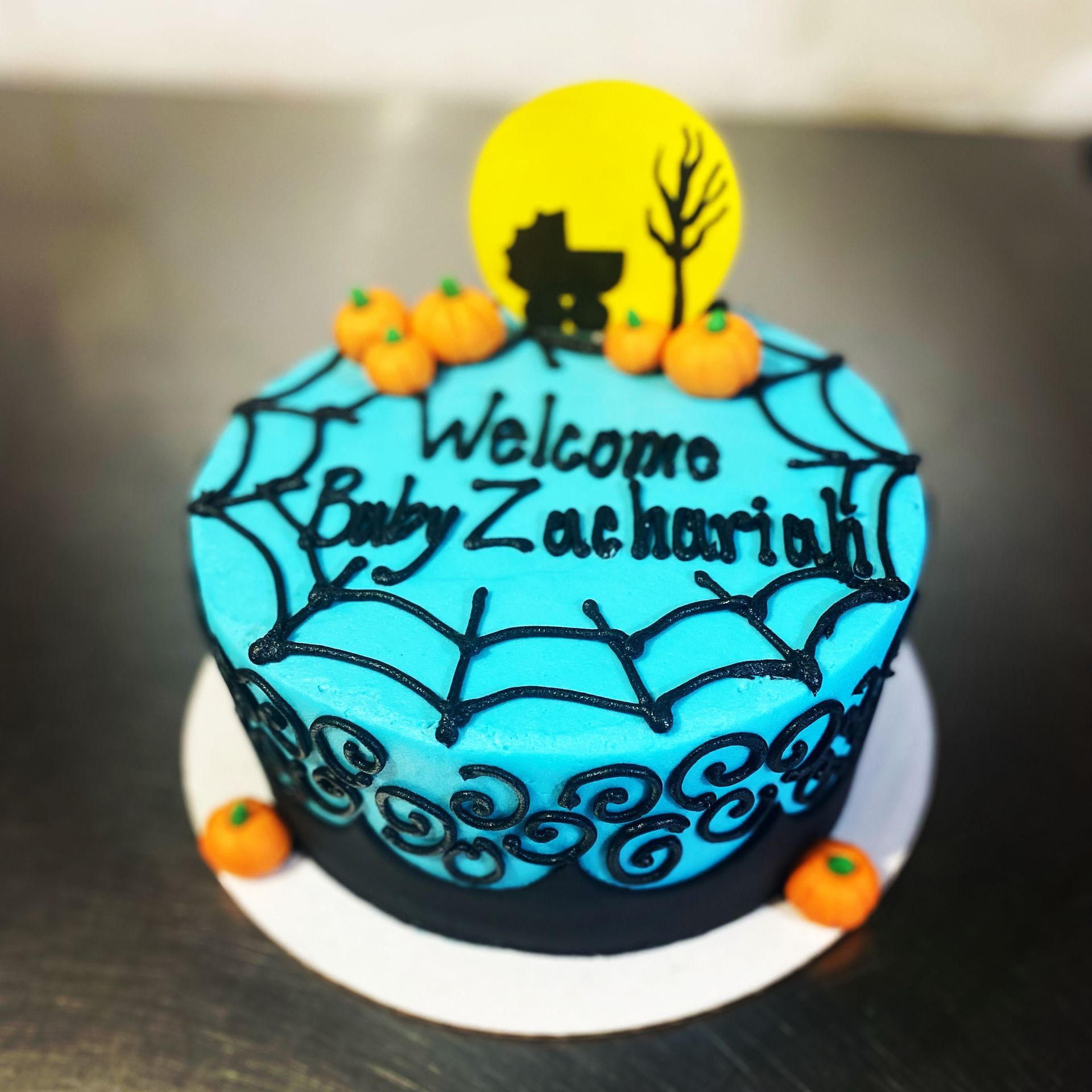 A baby shower cake that says welcome baby zachariah