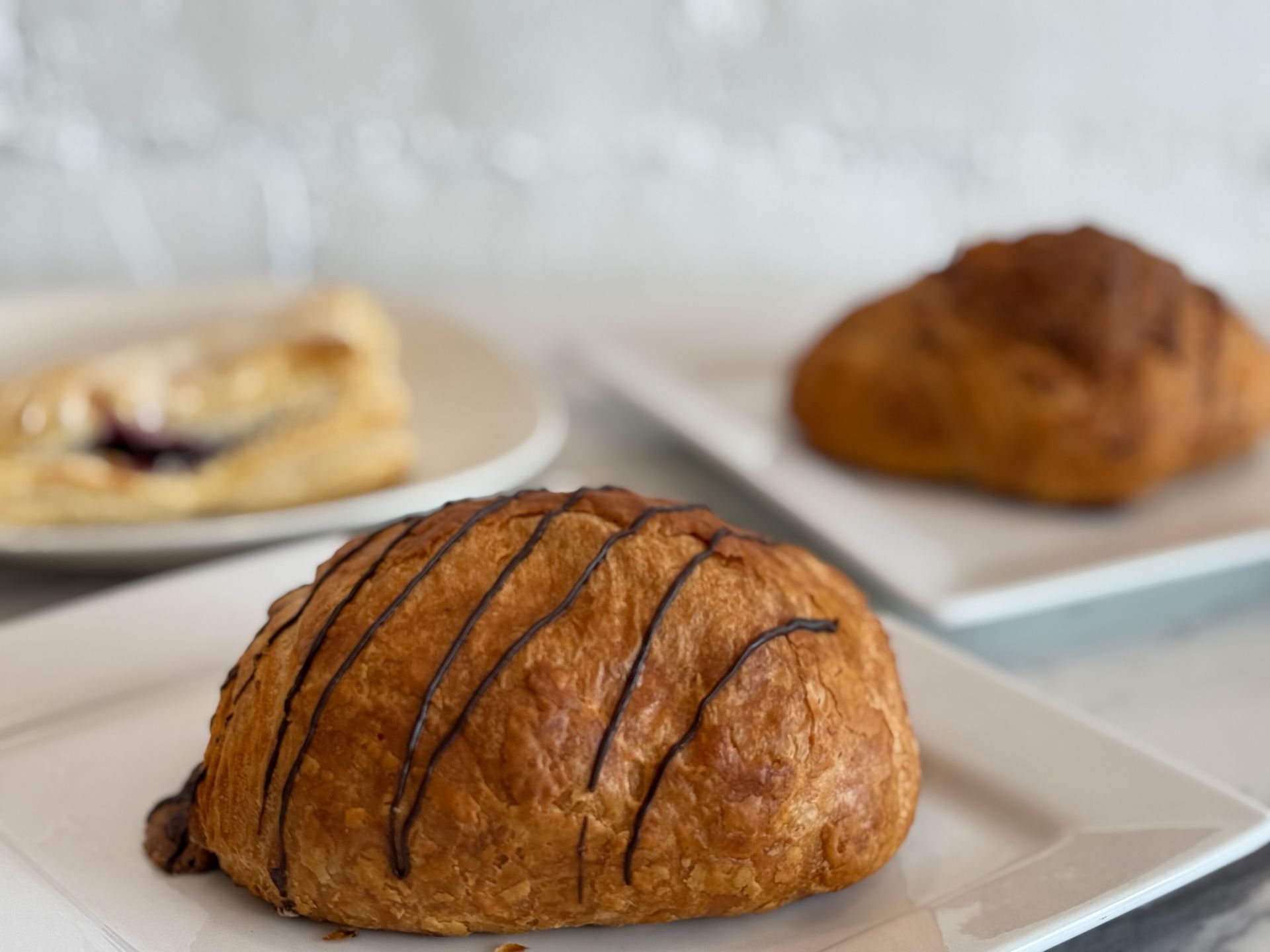 A close up of a croissant on a white plate