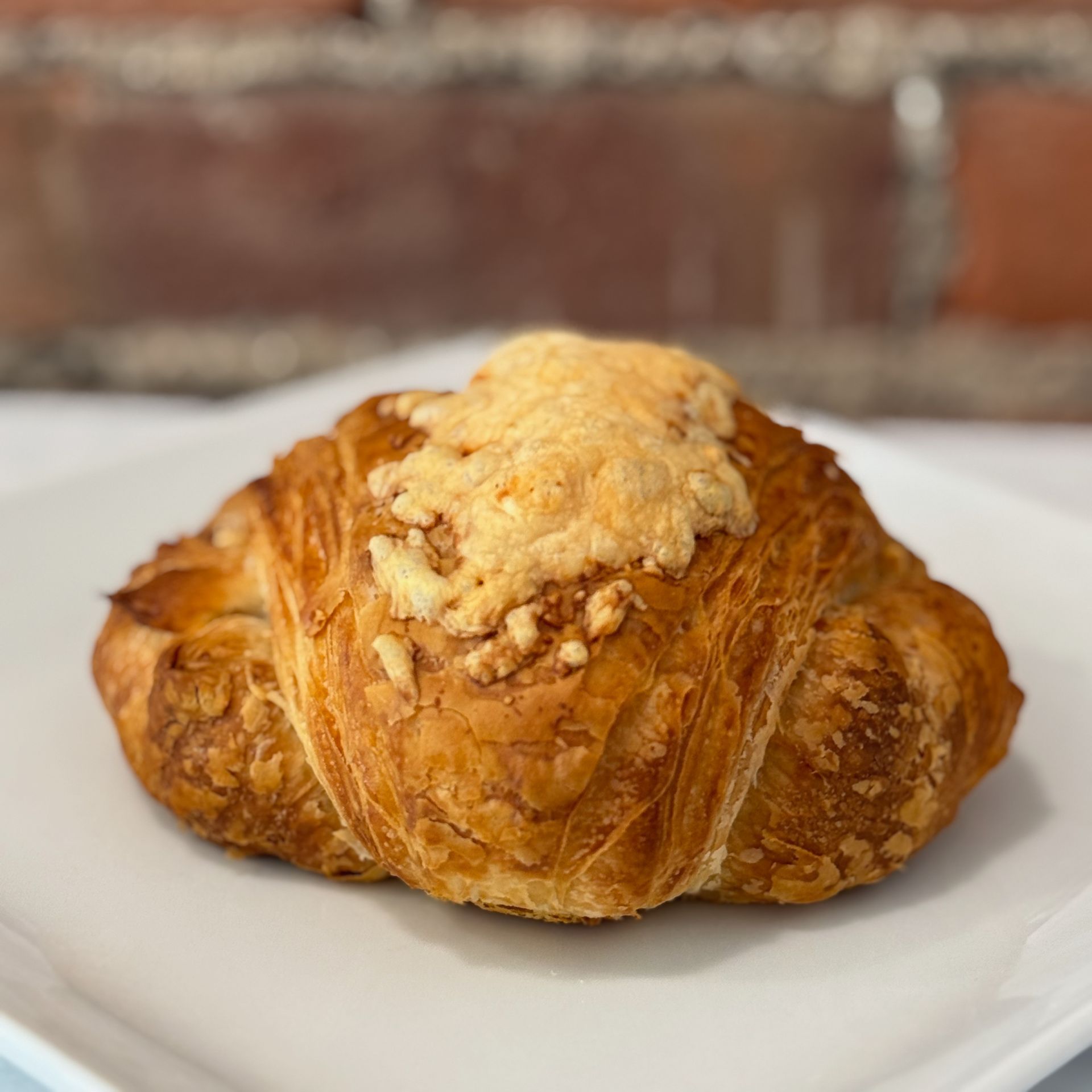 A close up of a croissant on a white plate.