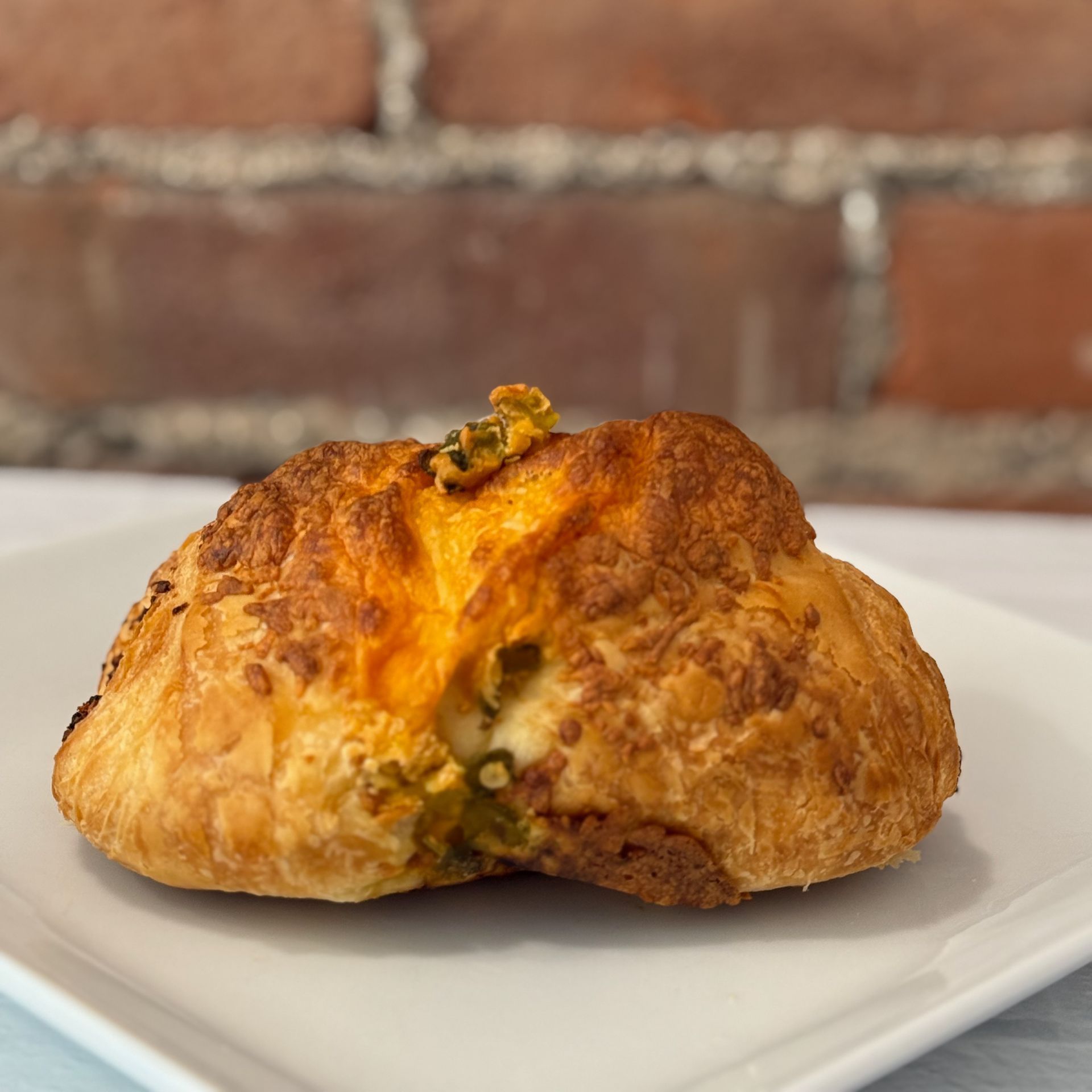 A close up of a croissant on a white plate