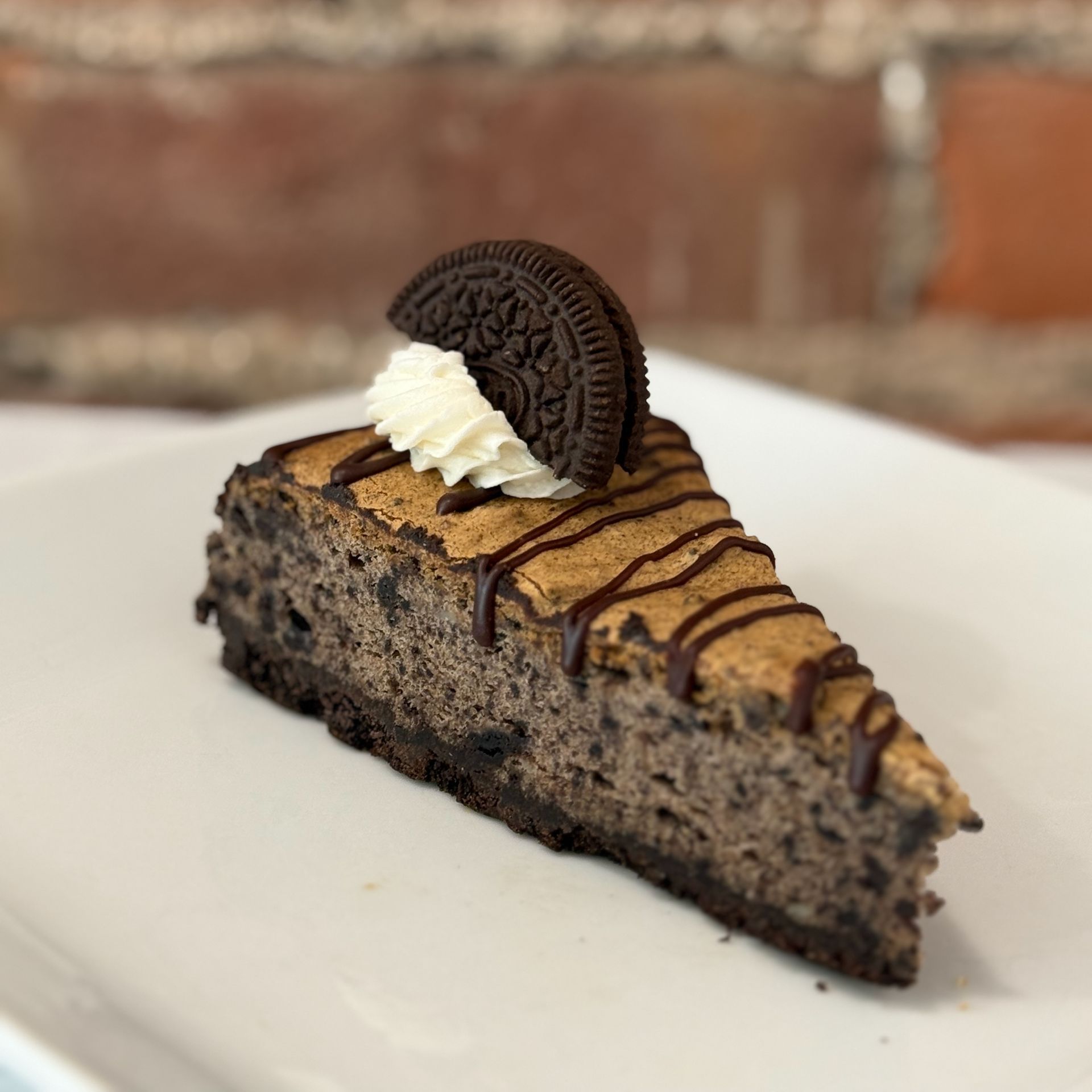A slice of oreo cheesecake on a white plate