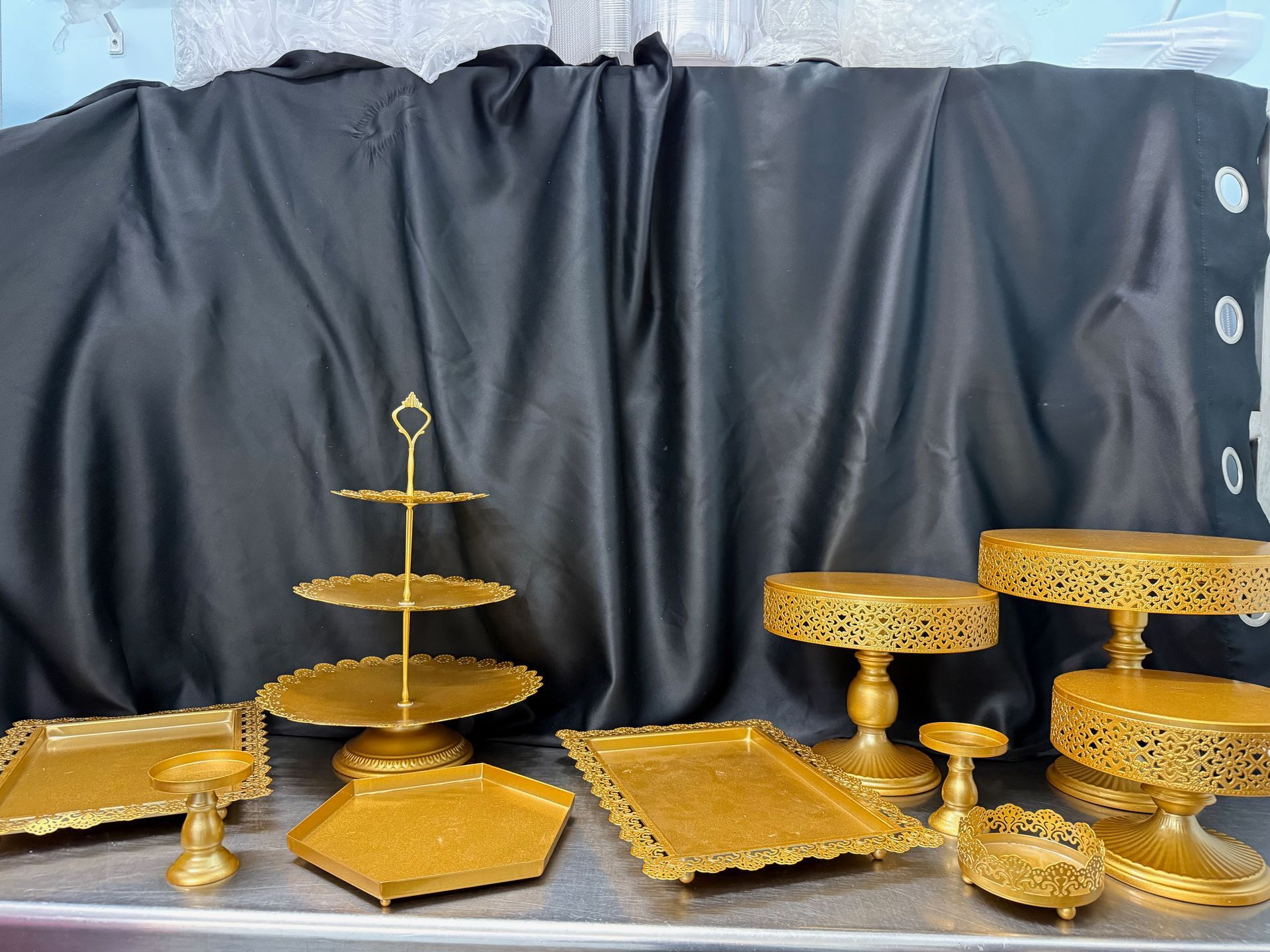 A bunch of gold plates and stands are sitting on a table.