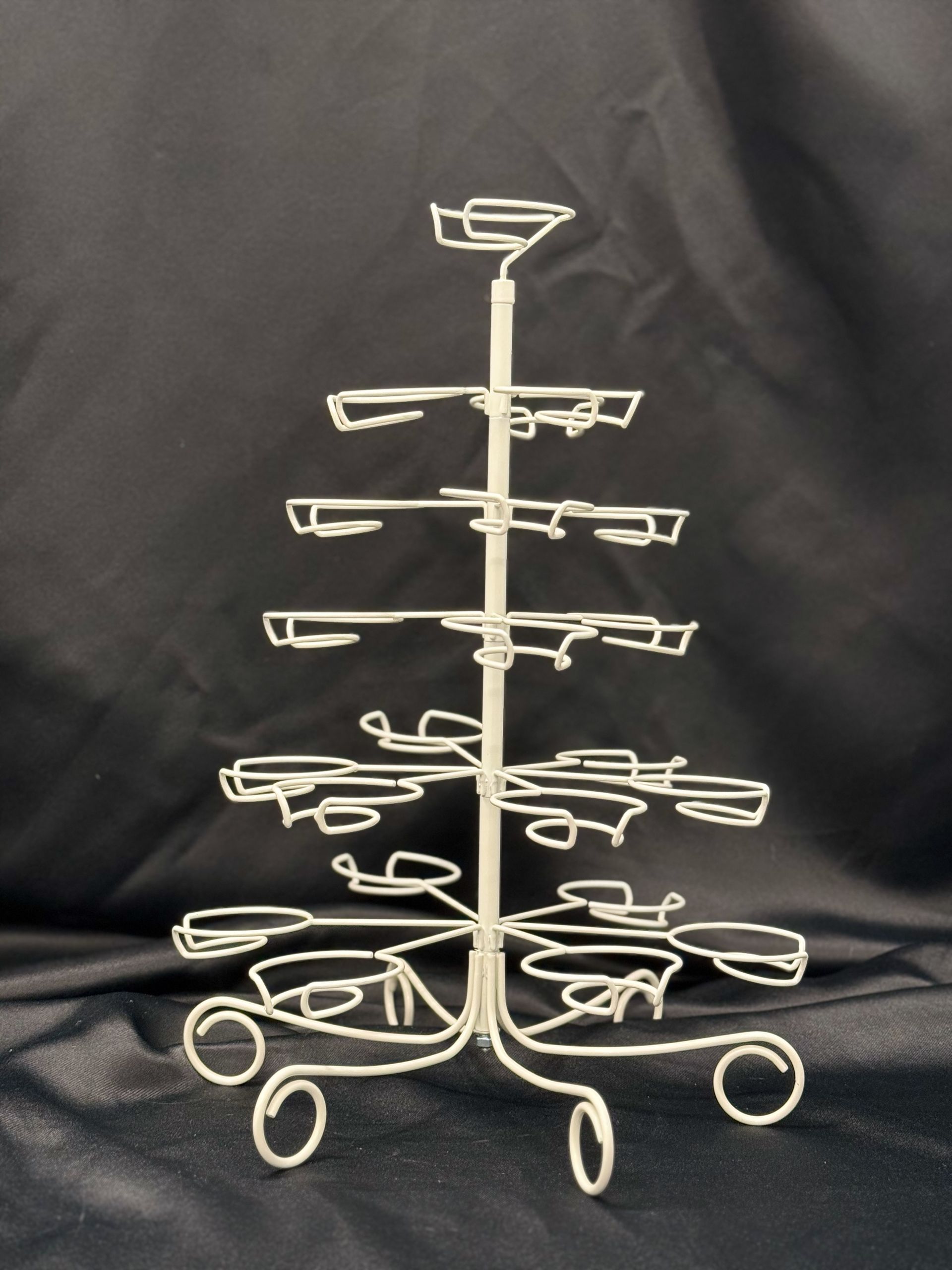 A white wire christmas tree with a black background