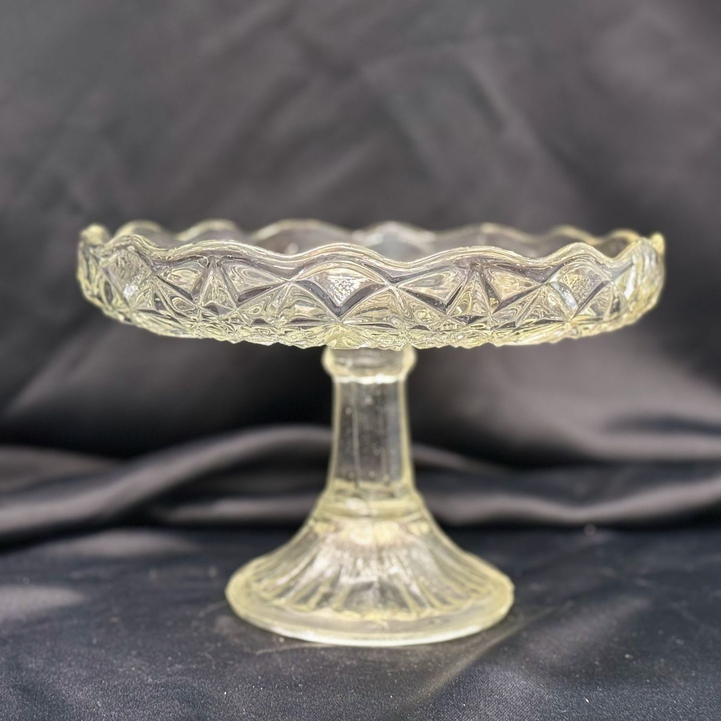 A woman is holding a cake in front of a cake me away sign.