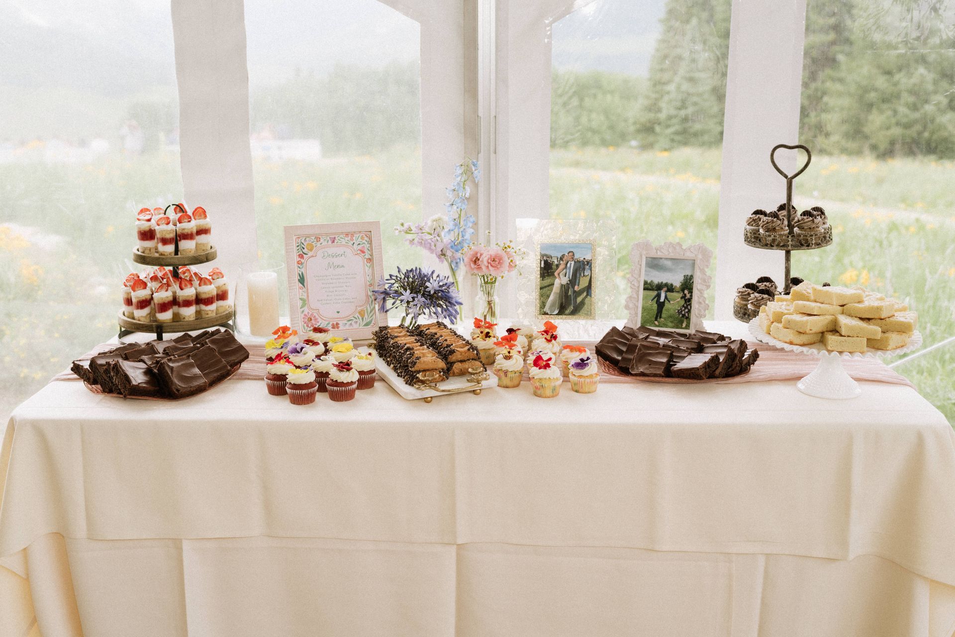 A table topped with a variety of desserts and cupcakes.