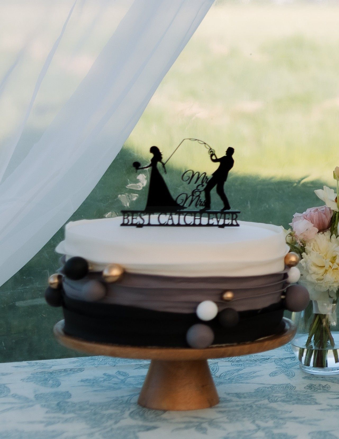 A wedding cake with a bride and groom on it