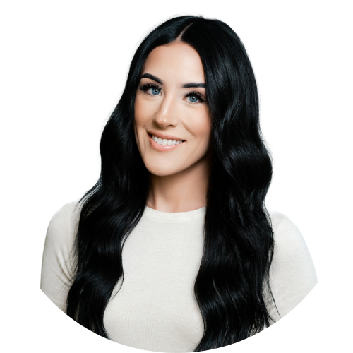 A woman with long black hair is wearing a white shirt and smiling.
