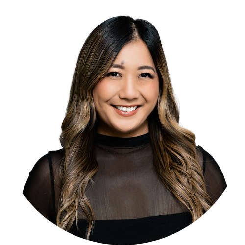 A woman with long hair is wearing a black shirt and smiling.