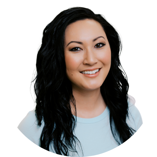 A woman with long dark hair is smiling and wearing a black shirt.