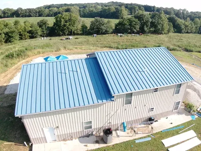 An aerial view of a building with a blue roof