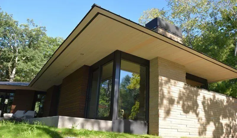 A house with a roof that has a lot of windows