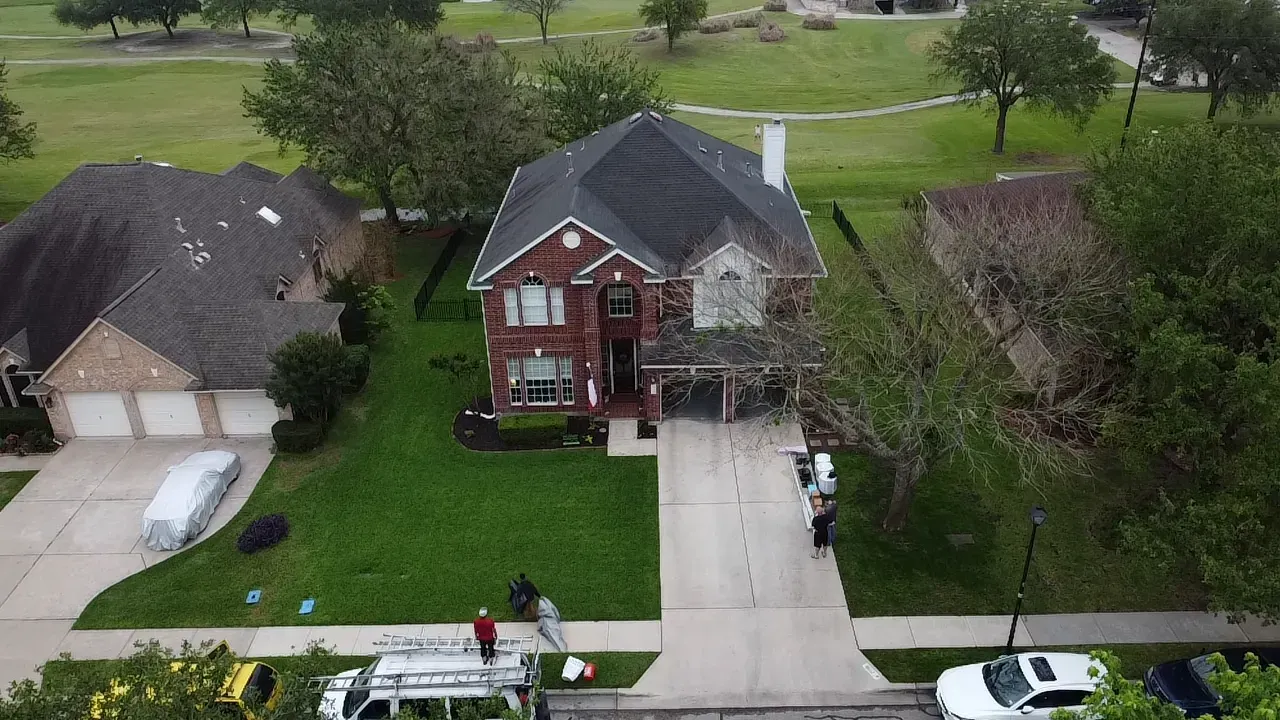 An aerial view of a house with a roof being installed.