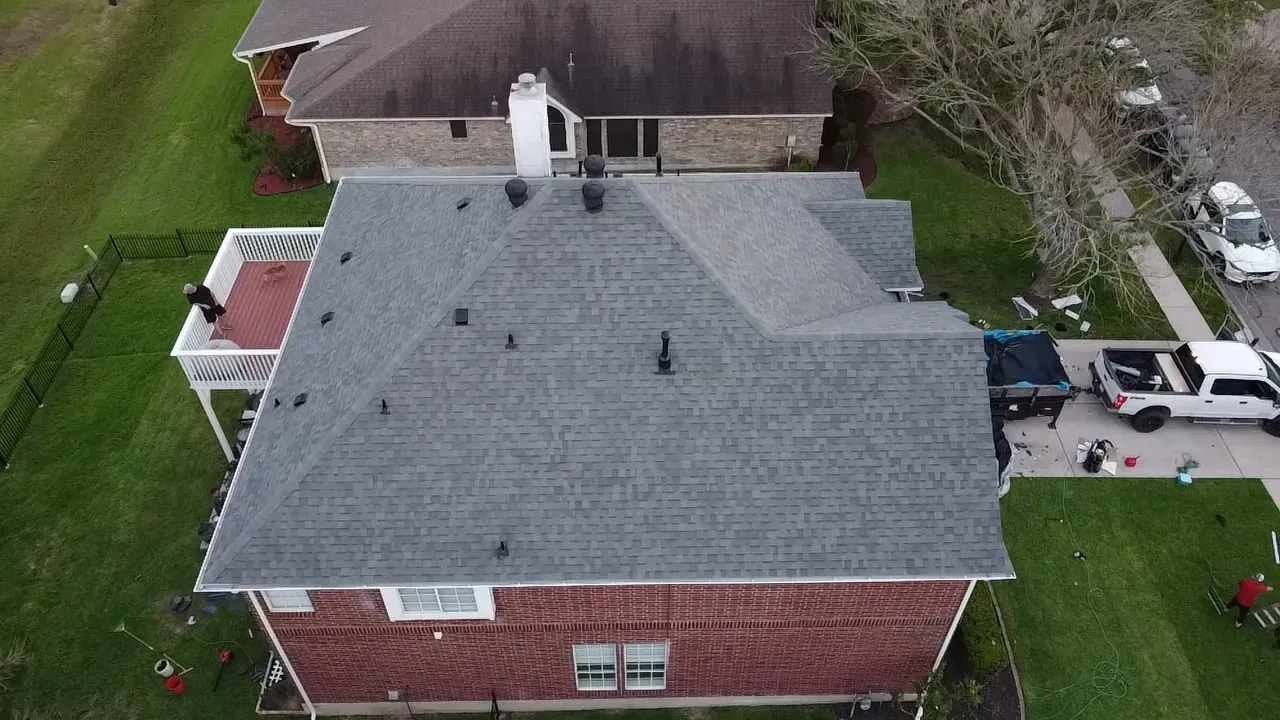 An aerial view of a house with a roof that is being installed.