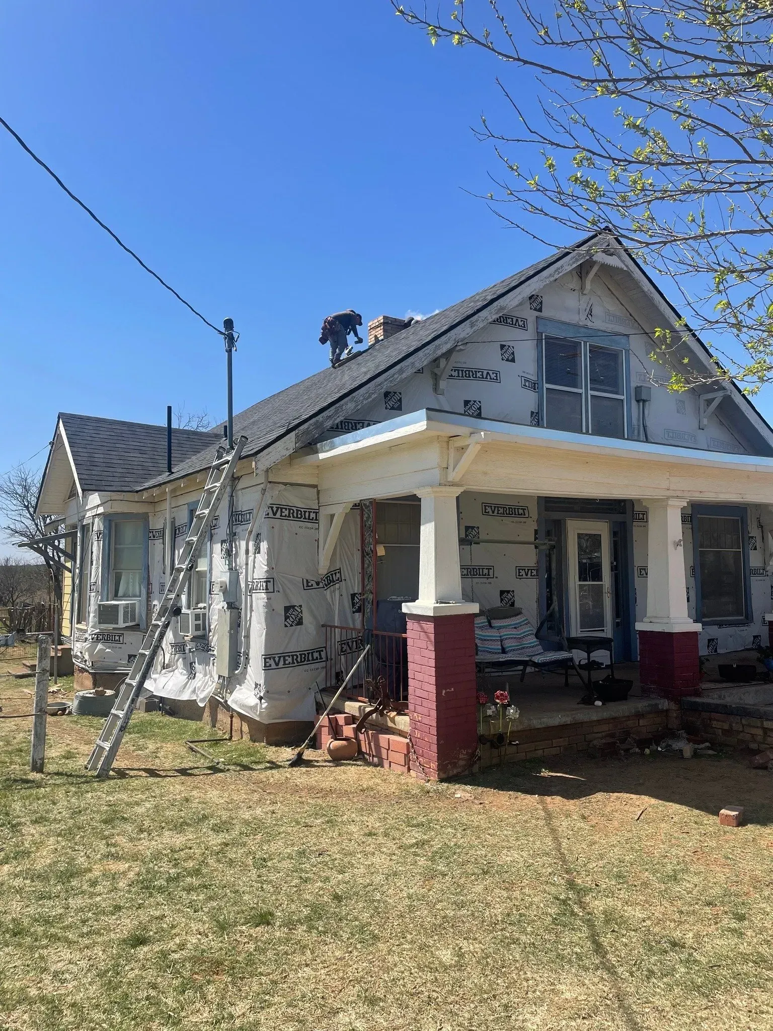 A man is working on the roof of a house.