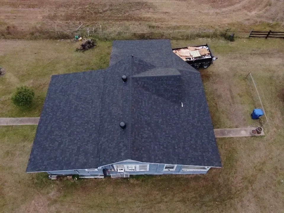 An aerial view of a house with a new roof.