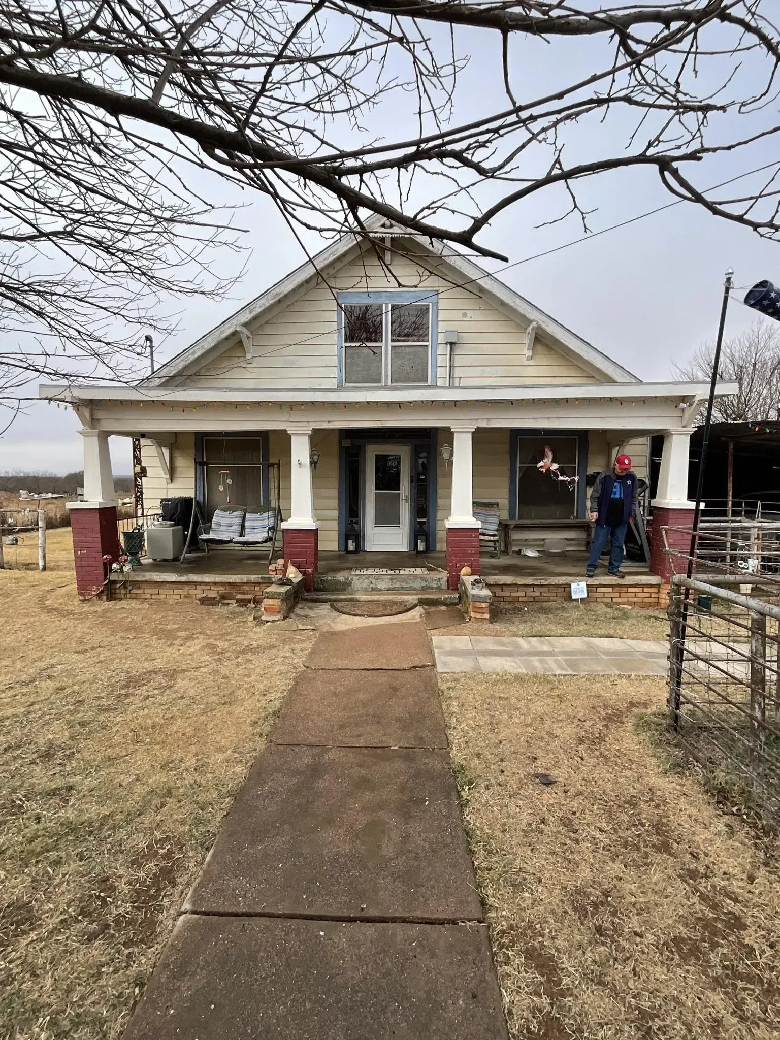 A house with a porch and a walkway leading to it.