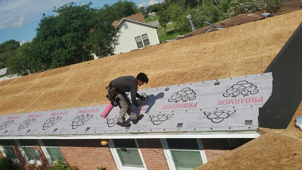 A man is working on the roof of a house