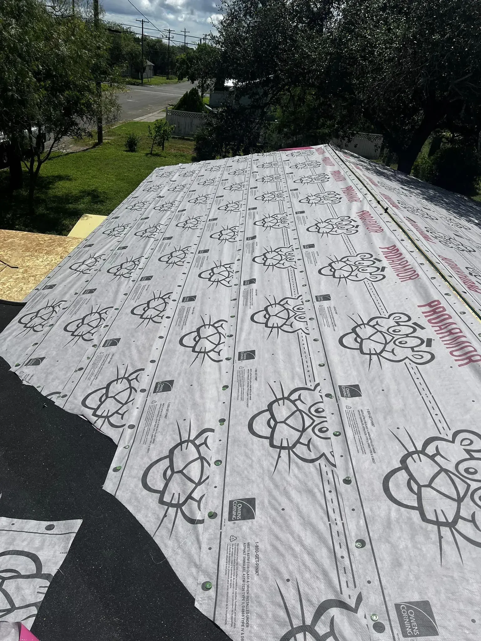 A large piece of paper is sitting on top of a roof.