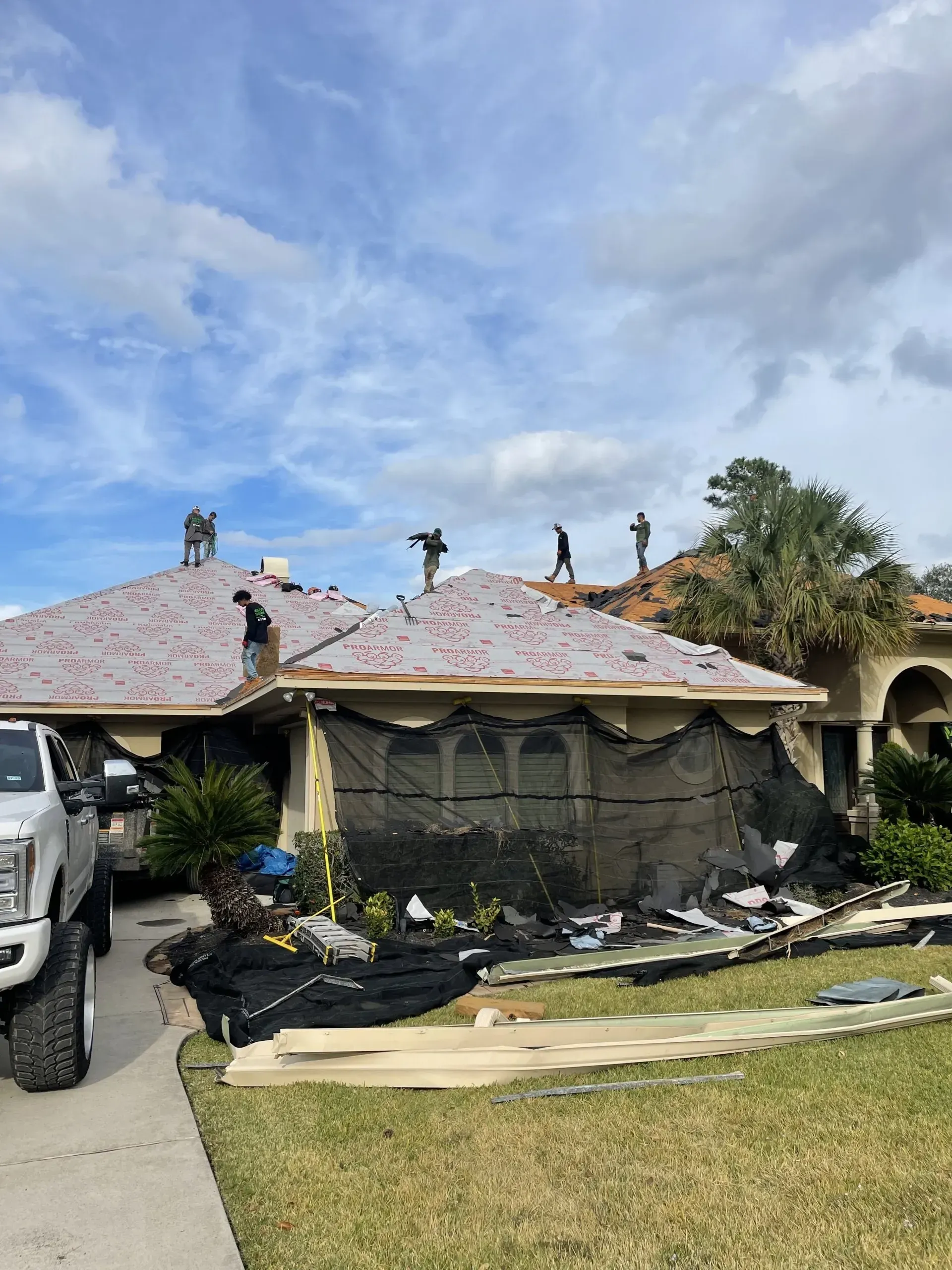 A truck is parked in front of a house that is being remodeled.