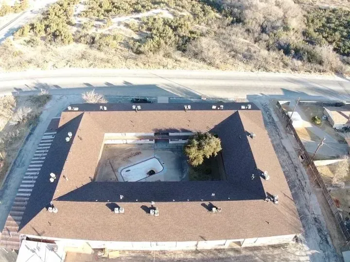 An aerial view of a building with a tree in the middle