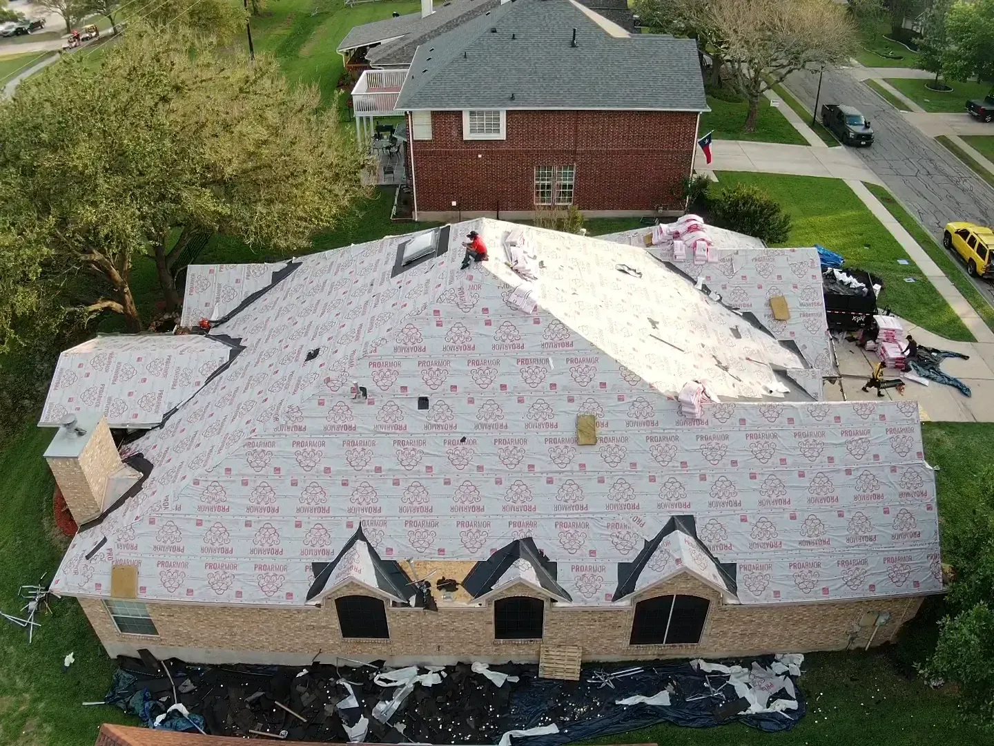 An aerial view of a house with a roof being installed.