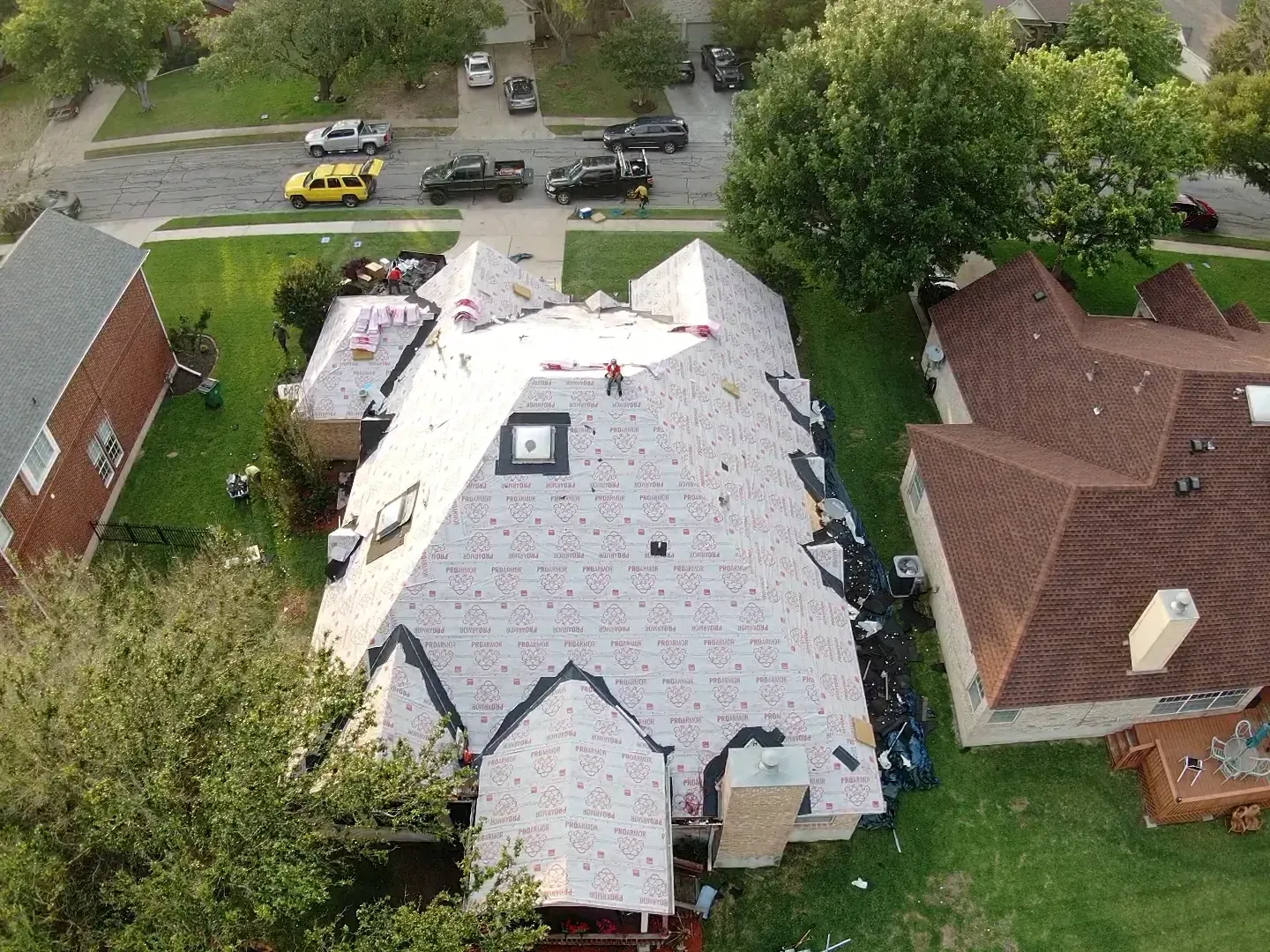 An aerial view of a house with a roof being installed