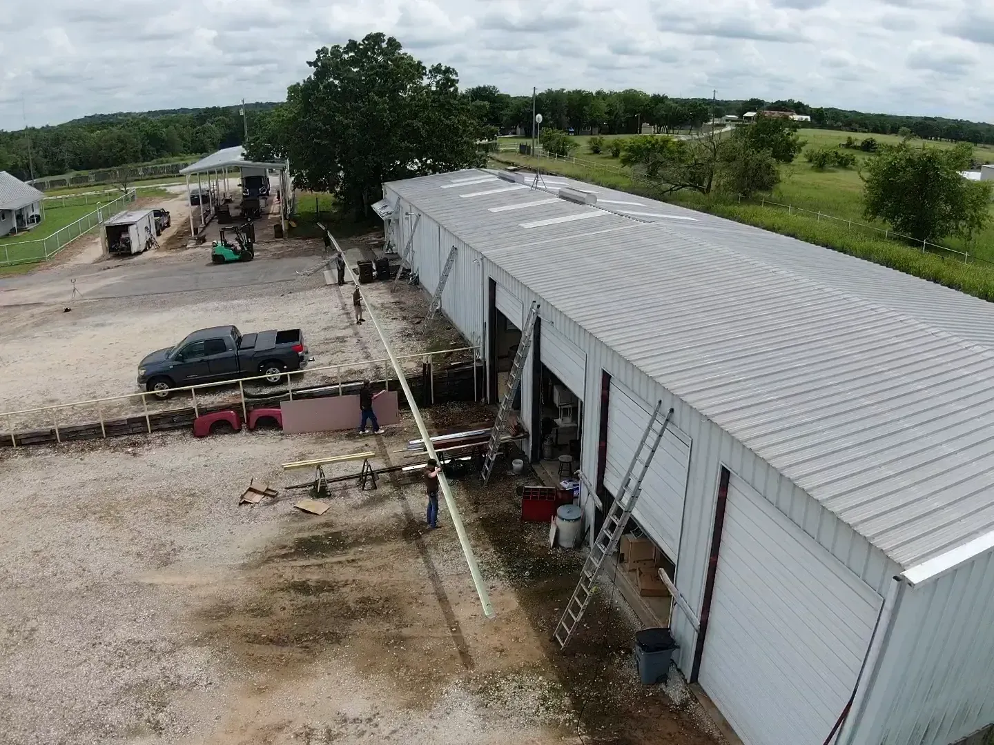 An aerial view of a building with a truck parked in front of it