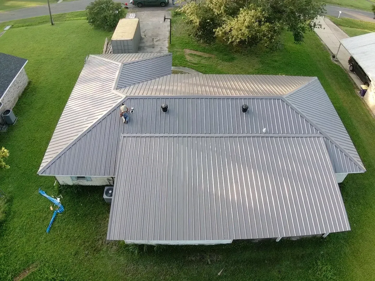 An aerial view of a house with a metal roof.