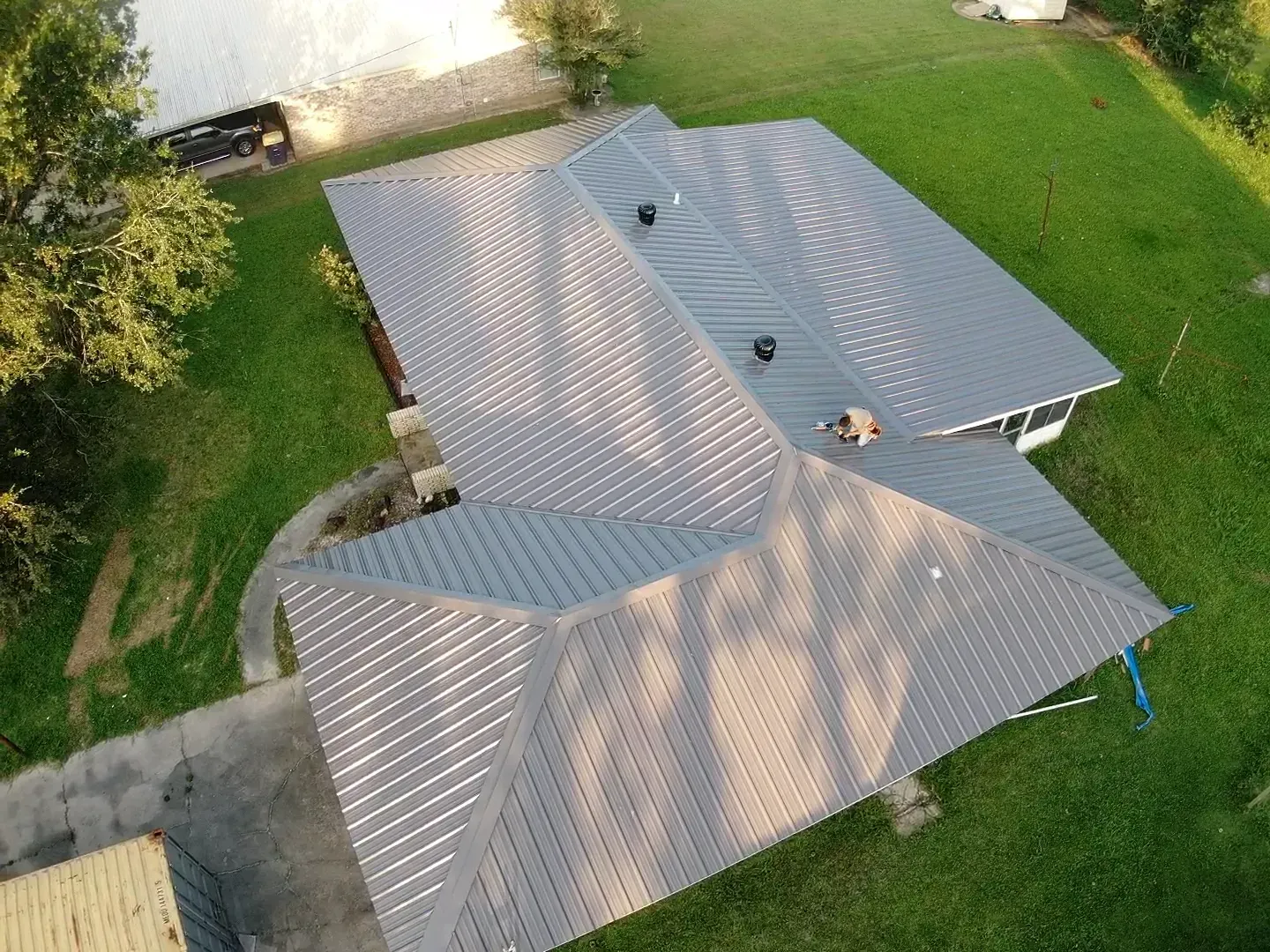 An aerial view of a house with a metal roof.