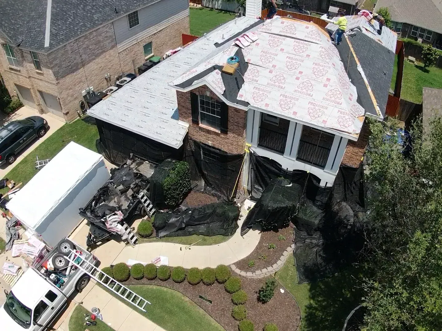 An aerial view of a house with a white truck parked in front of it.