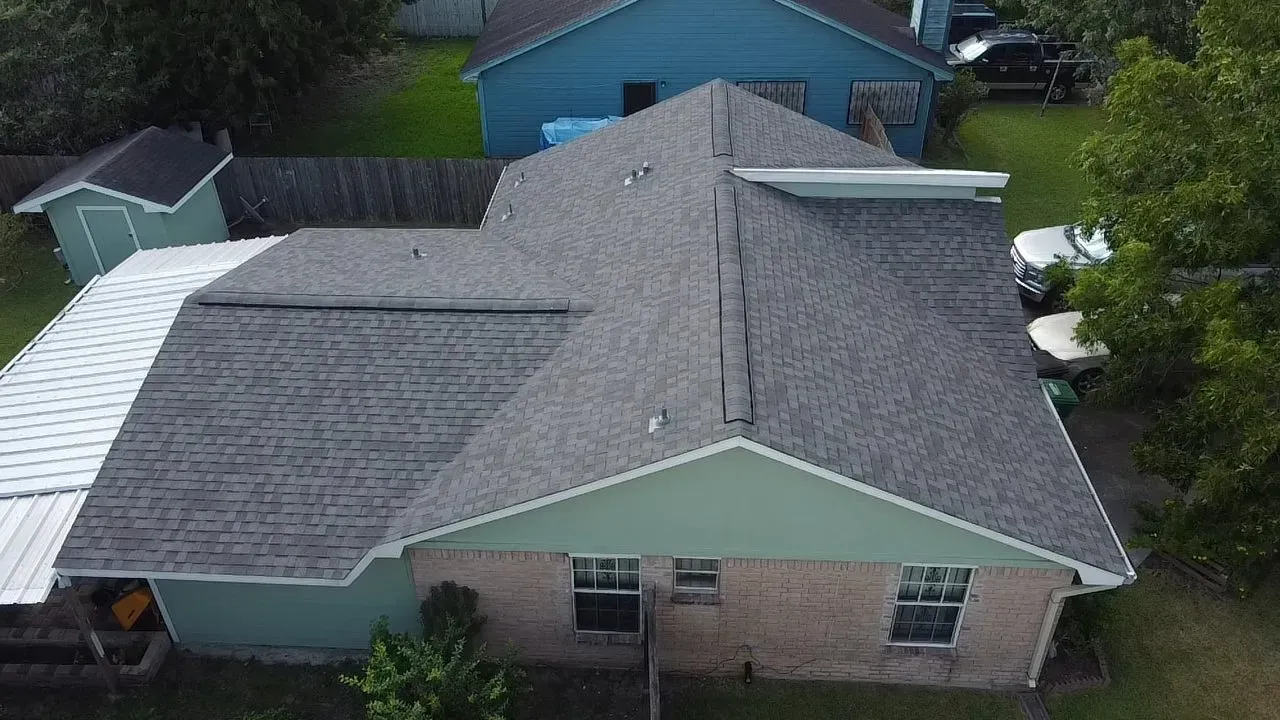 An aerial view of a house with a new roof.