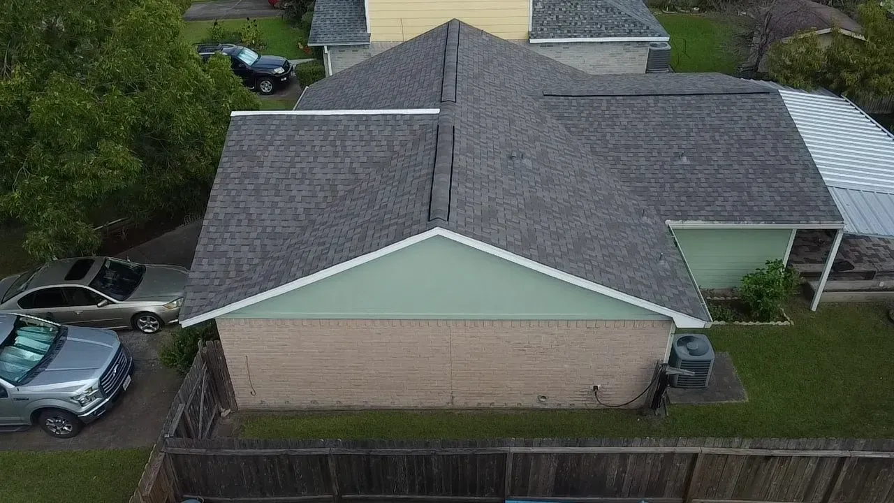 An aerial view of a house with a roof that has been installed.