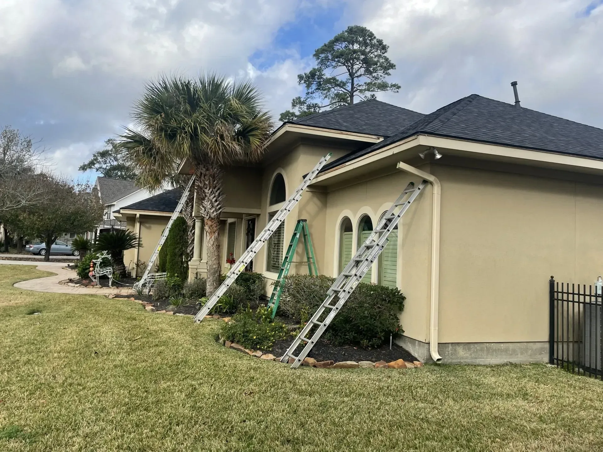 A house with a ladder leaning against it in front of it.