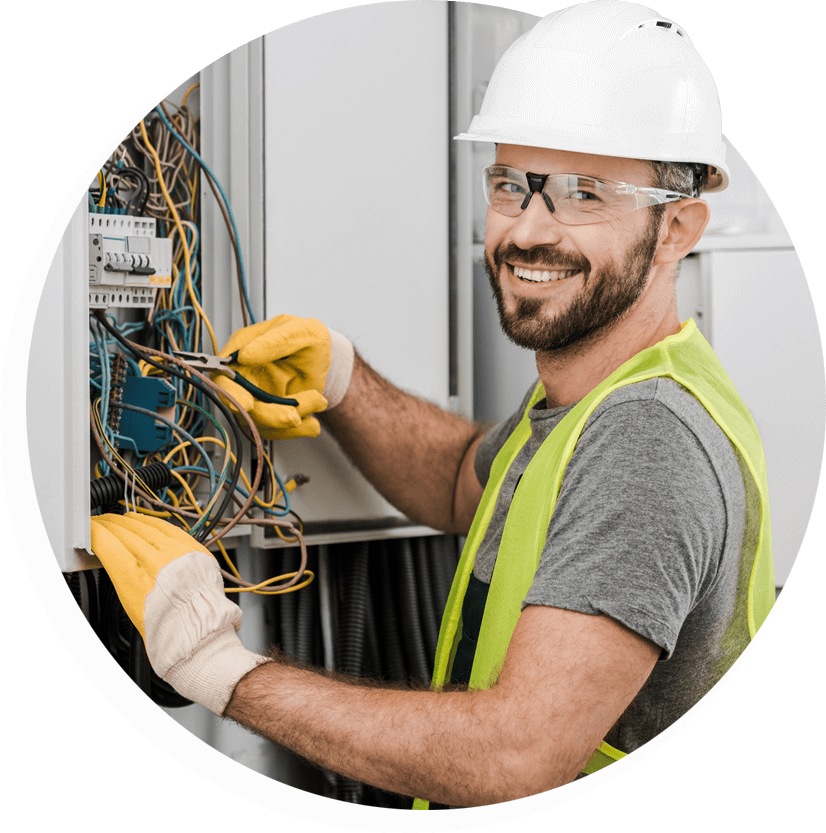 happy electrician working on electrical panel
