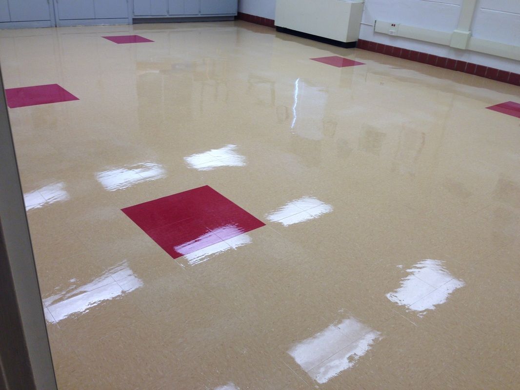 A shiny floor with red squares on it
