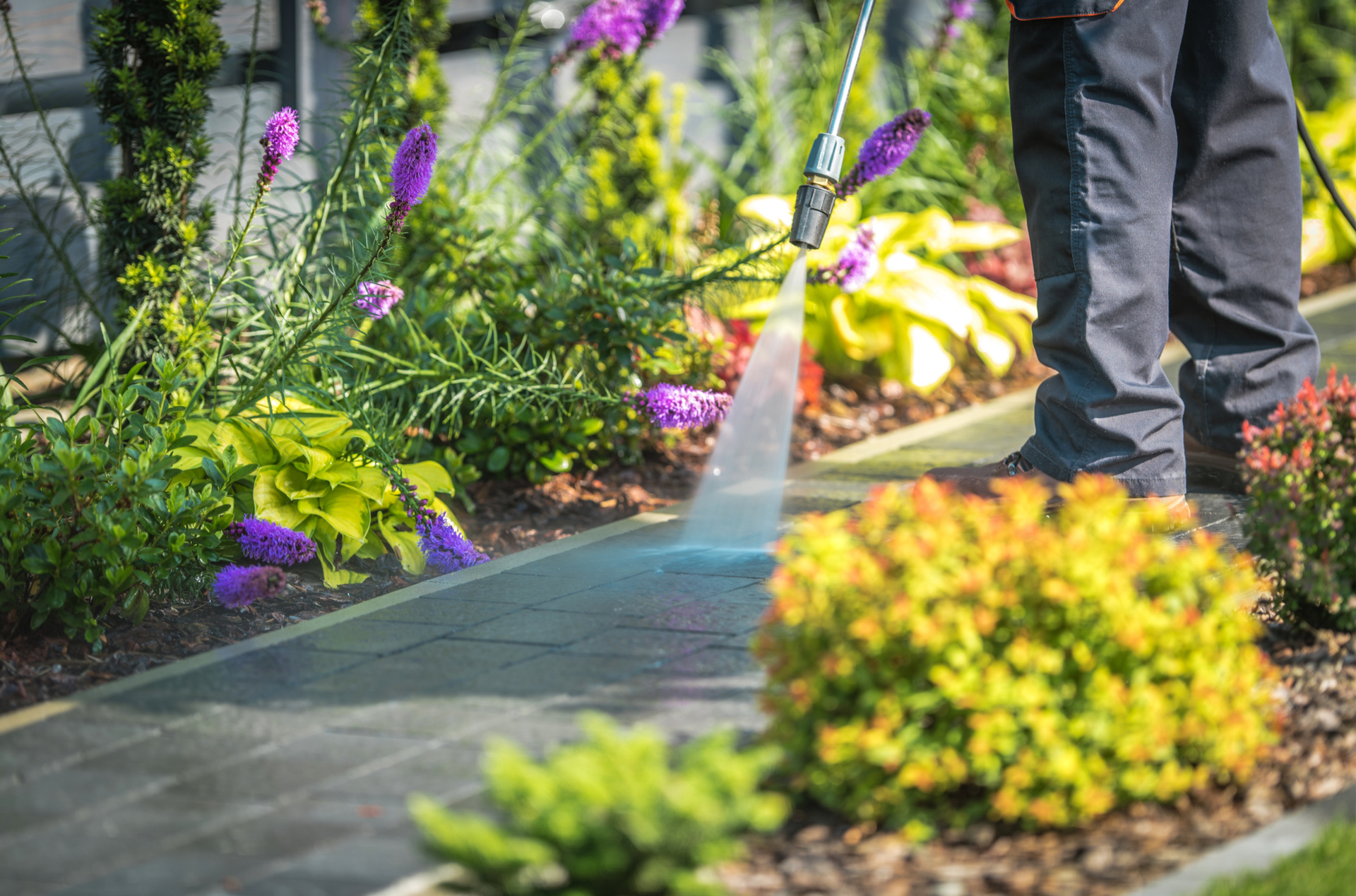 A man and a woman are mopping the floor in a room
