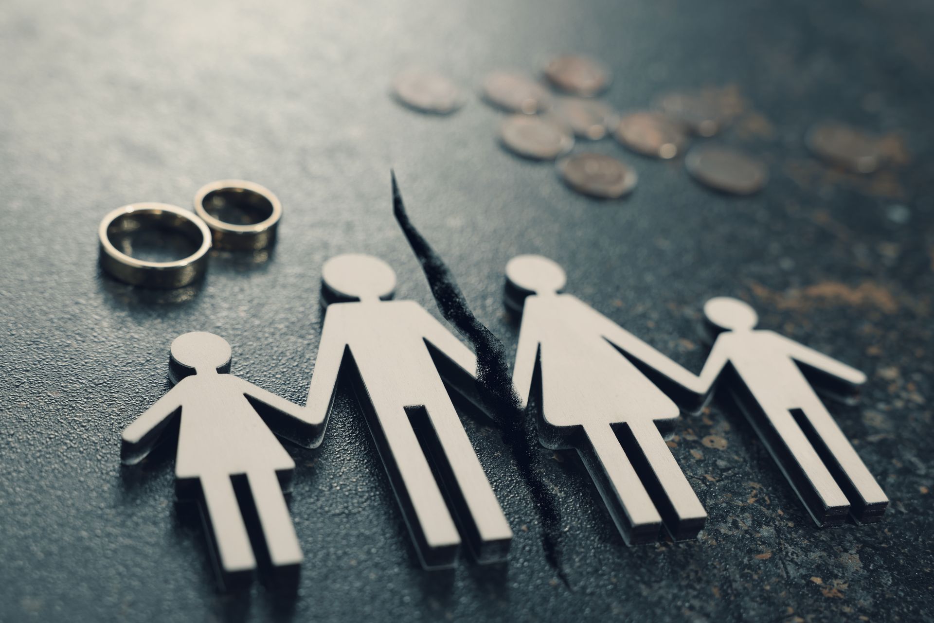 Divorce and alimony concept. Family figure with a crack between the wife and husband on the table. 