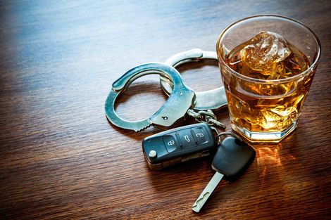 A Glass Of Alcohol And Key On A Table — Green Bay, WI — Brabazon Law Office LLC