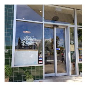 Picture of the front of a cafe with the name Francis Winifred on the front glass windows.