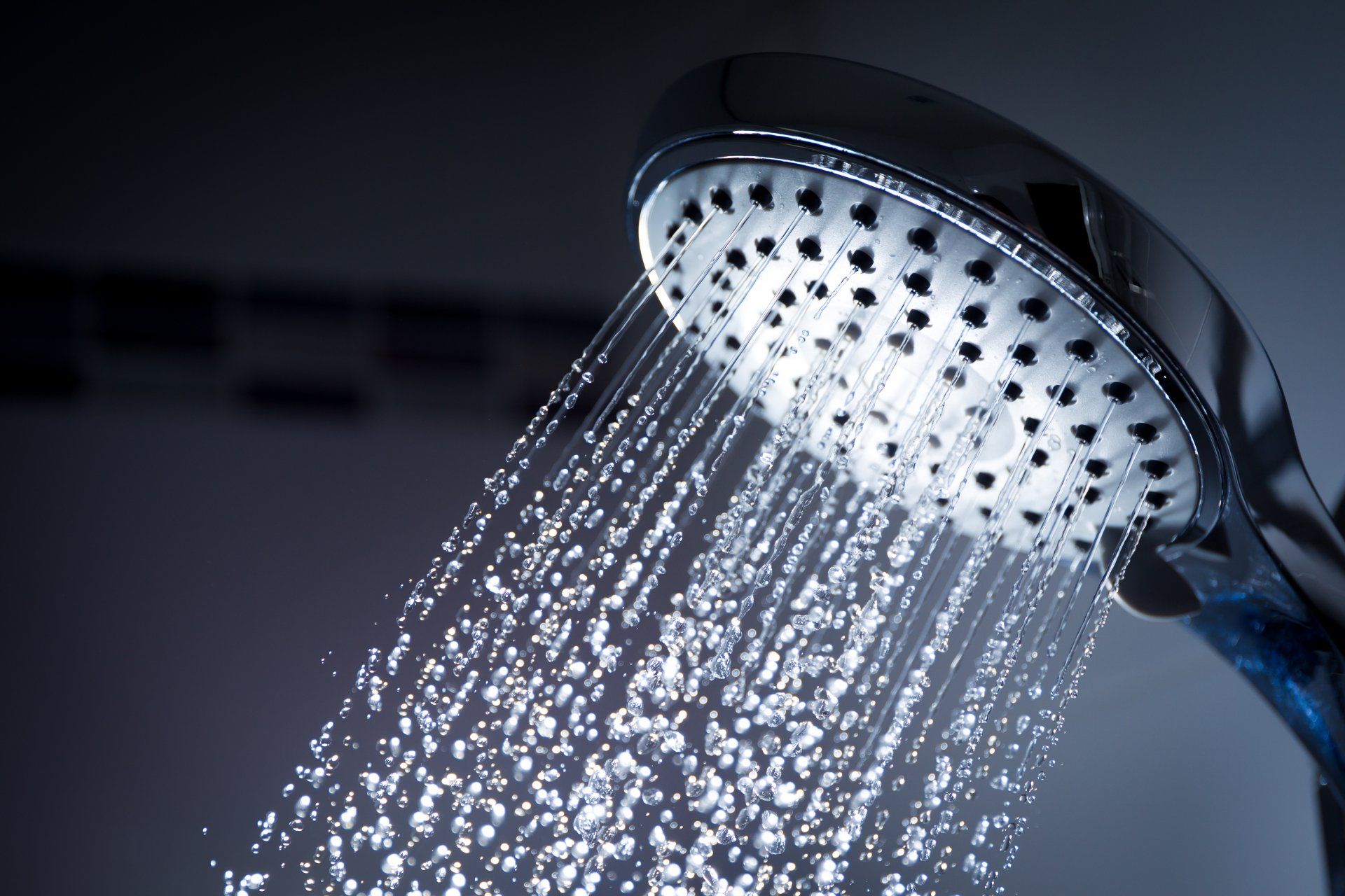 Shower head with water coming out of it. Classic shower image.