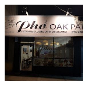 Picture of Pho Oak Park restaurant  overhead sign illuminated with light at night time.
