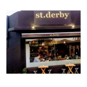 Image shows inside entrance of st. derby cafe, with lights on and people inside.