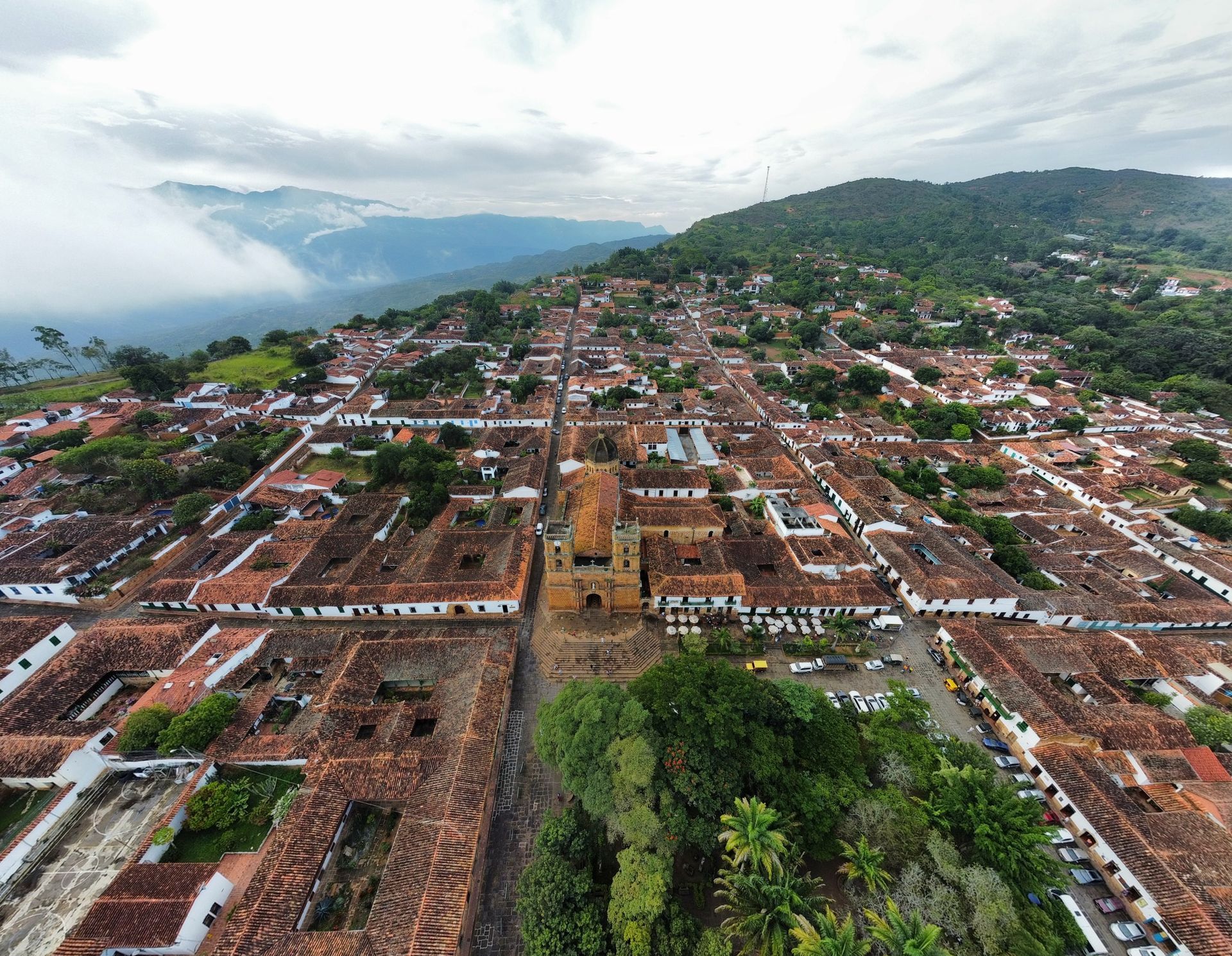 An aerial view of a small town with a church in the middle of it. Barichara Colombia.