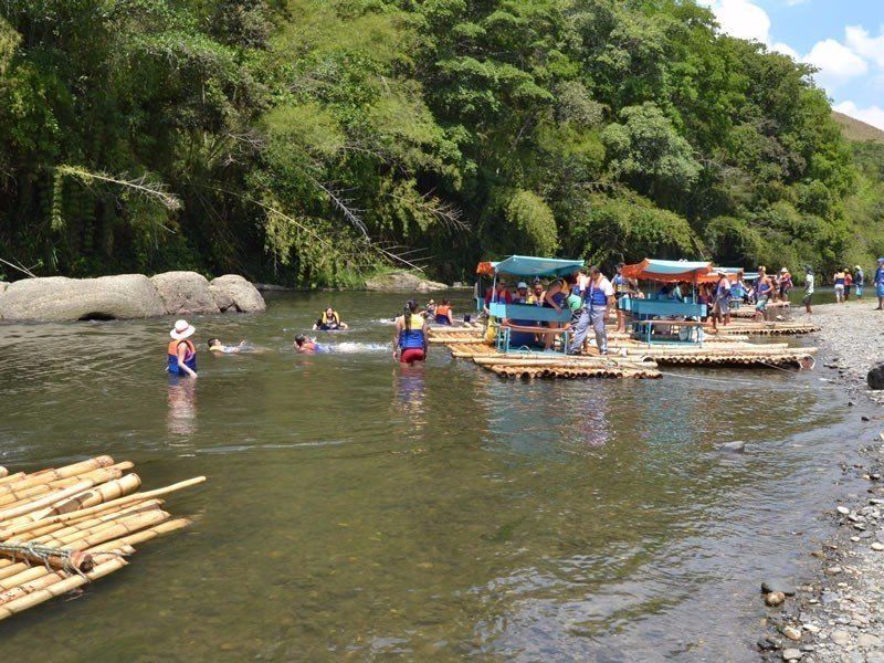 A group of people are floating on rafts in a river