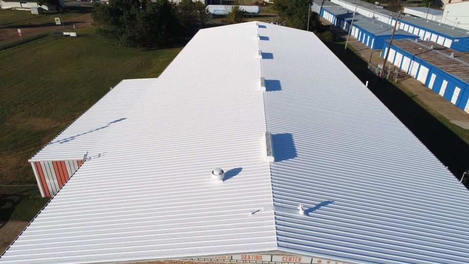 An aerial view of a white and blue roof of a building.