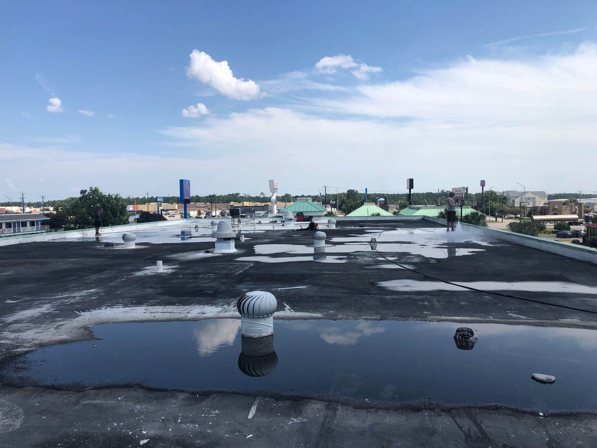 A roof with a lot of water on it and a blue sky in the background.
