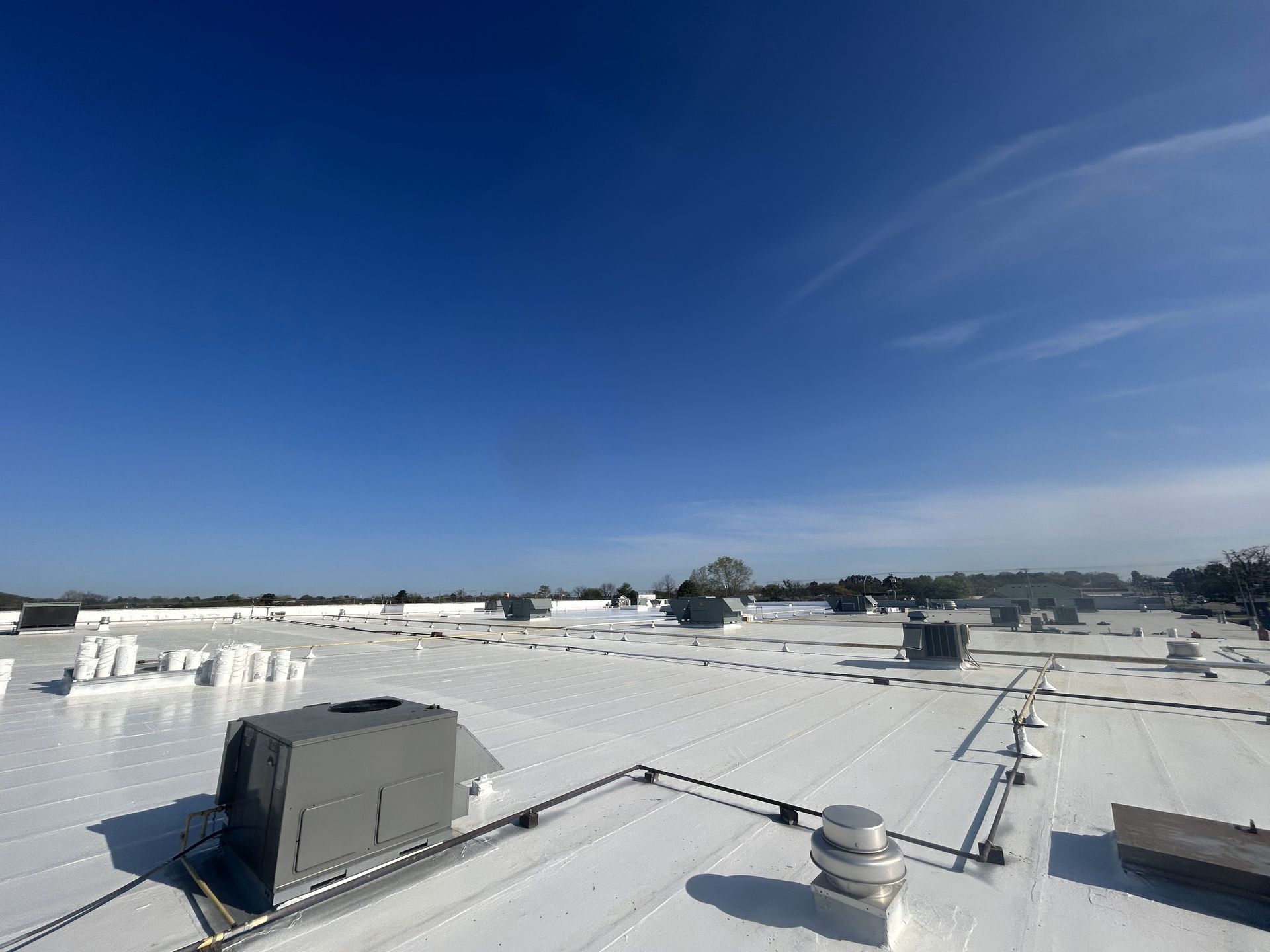 A white roof with a blue sky in the background