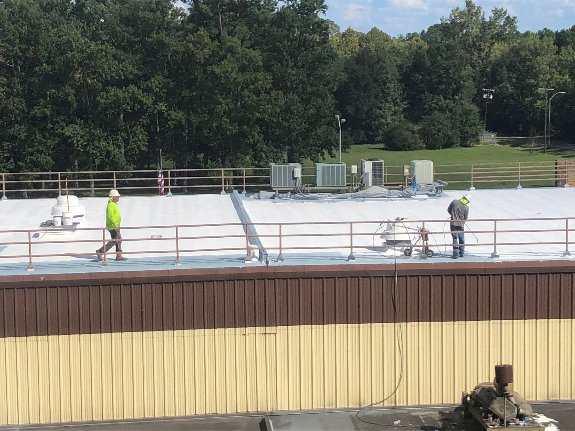 Two men are working on the roof of a building