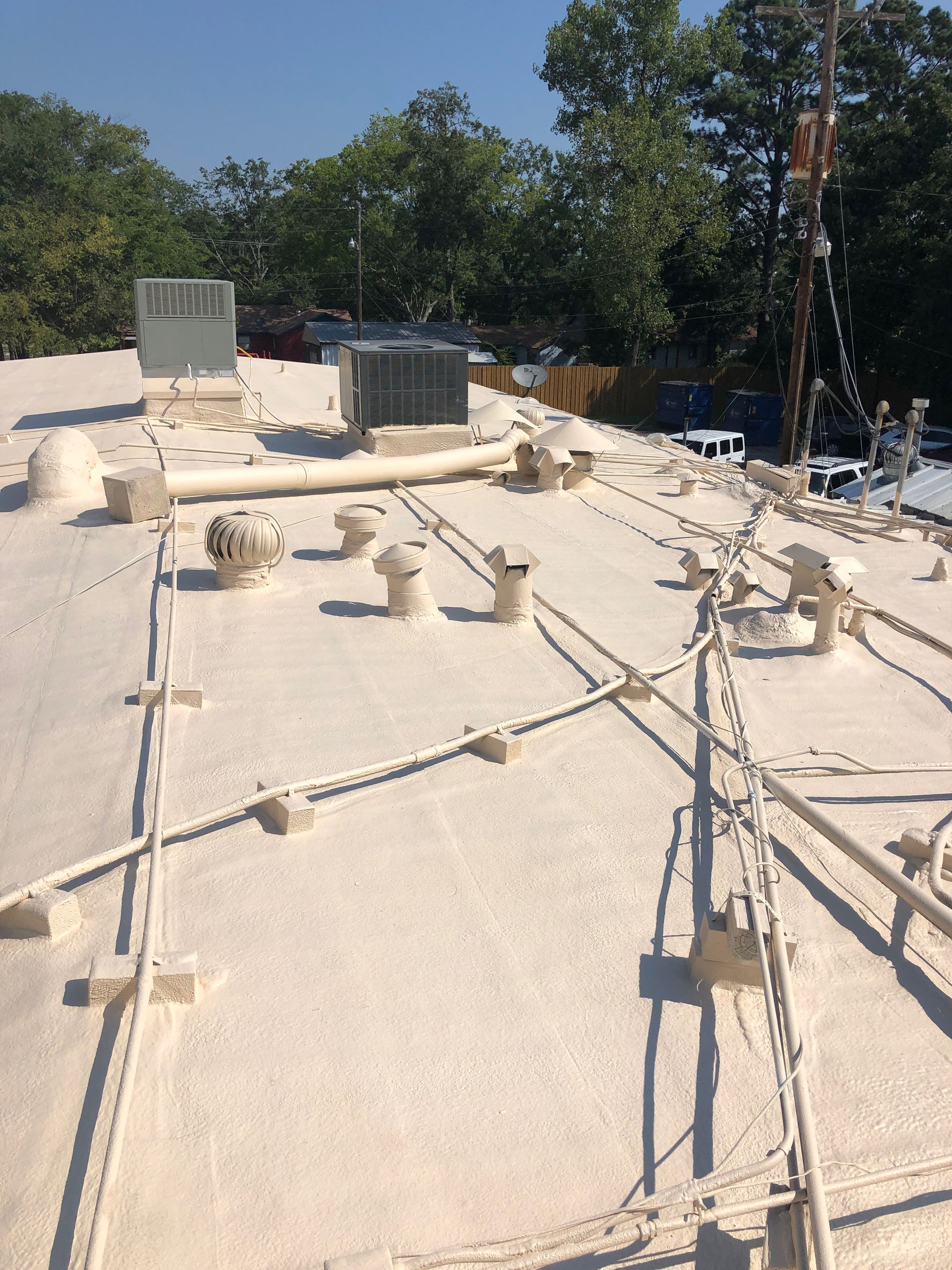 A white roof with a lot of wires on it